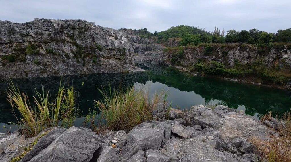 Blue-green lagoon surrounded by limestone cliffs near Pha Man, Thailand
