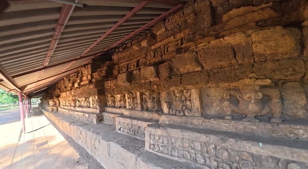 Ancient stucco relief figures on the base of Khao Klang Nai at Si Thep