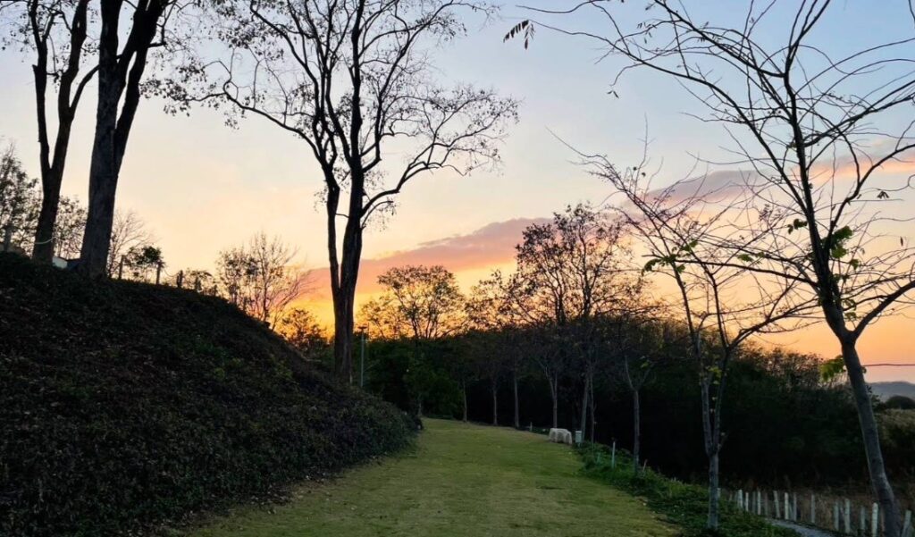 Peaceful sunset and tent overlooking the countryside at a quiet campsite in Saraburi, Thailand