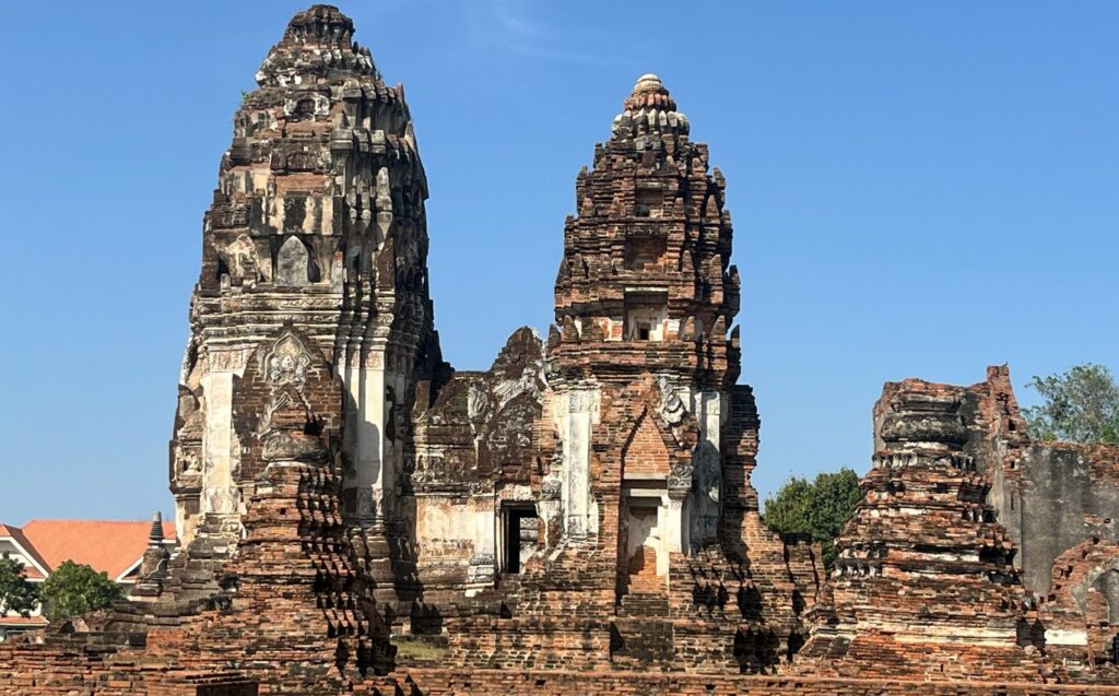 Towering central prang surrounded by ancient ruins at Wat Phra Si Rattana Mahathat