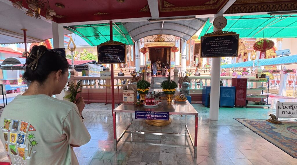 Paying respect to the statue of King Taksin at Wat Lum Mahachai Chumphon in Rayong.