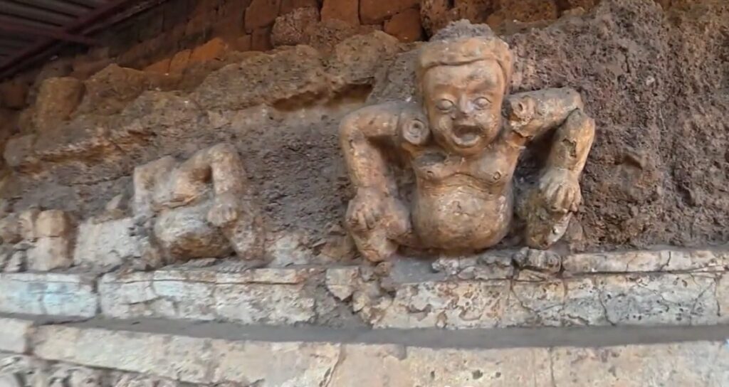 Close view of a surviving ancient relief at Khao Klang Nai in Si Thep