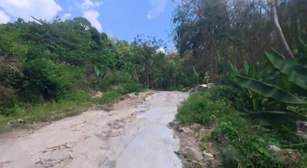 Steep rocky mountain road leading to Khao Makhem campsite in Rayong