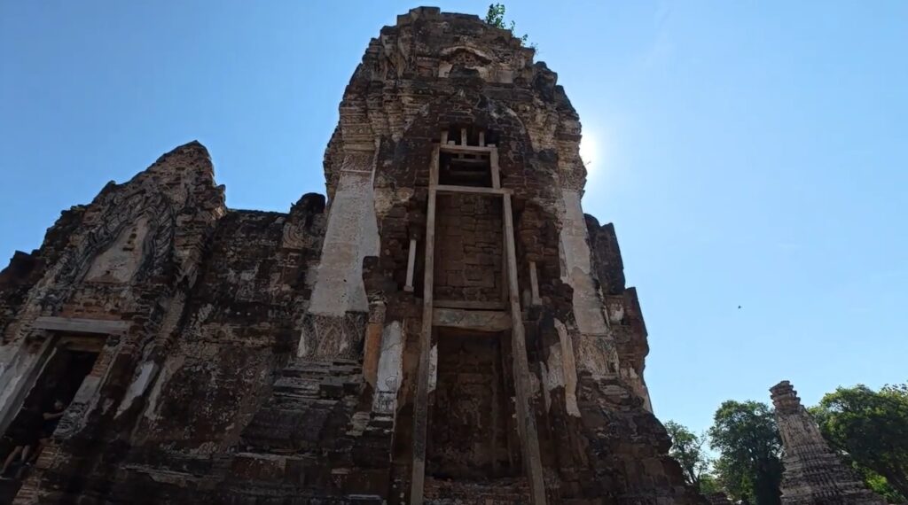 Weathered entrance and surviving stucco decoration on an ancient prang in Lopburi