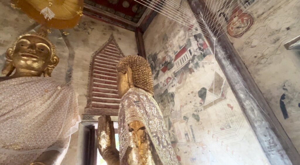 Standing Buddha and ancient murals inside Wat Tapon Noi