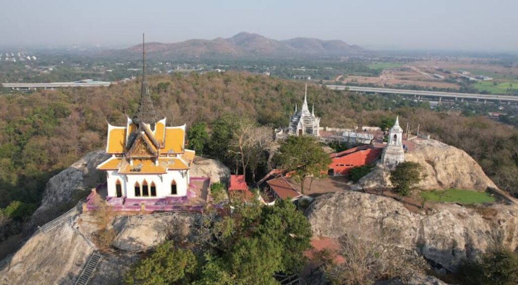 Wat Phra Phutthachai temple rising above the rocky mountain in Saraburi, Thailand