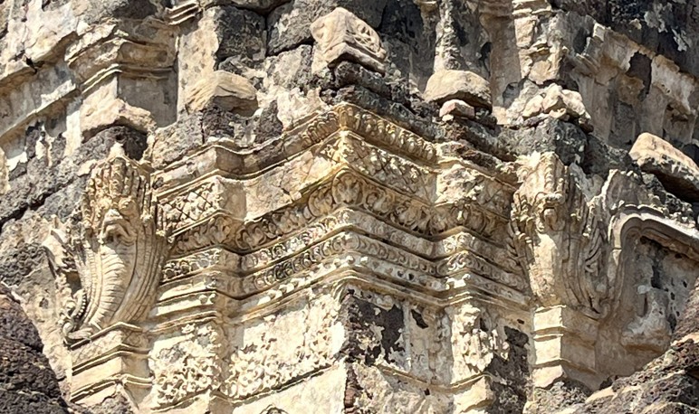 The layered stonework and recessed doorway reveal the surviving beauty of Khmer architecture.