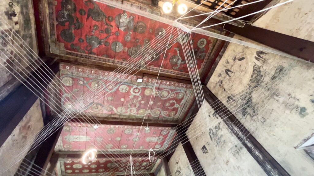 Red ceiling with golden patterns inside Wat Tapon Noi