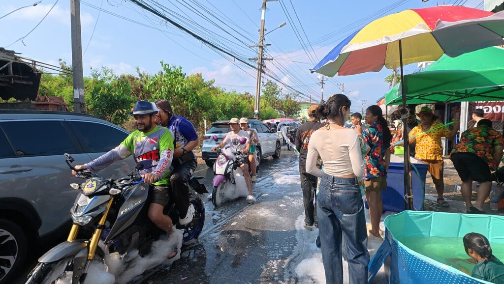 Riders enjoying the local Songkran water festival near Phala Beach