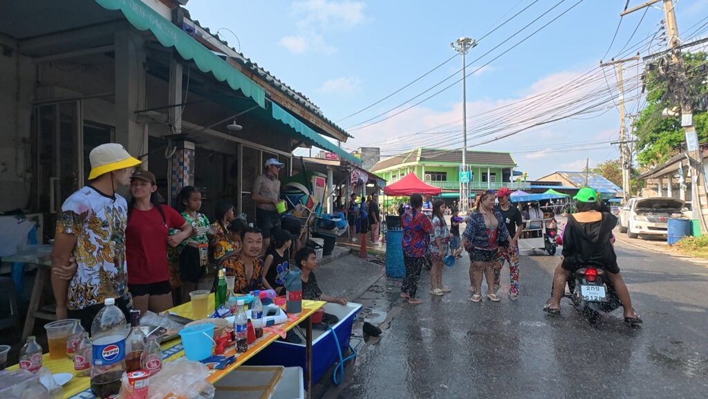 Local families celebrating Songkran together on a neighborhood street