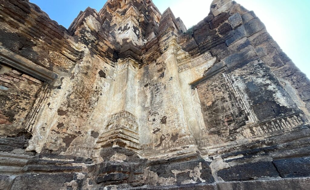 Ancient sculpted figures and weathered reliefs at Phra Prang Sam Yot in Lopburi
