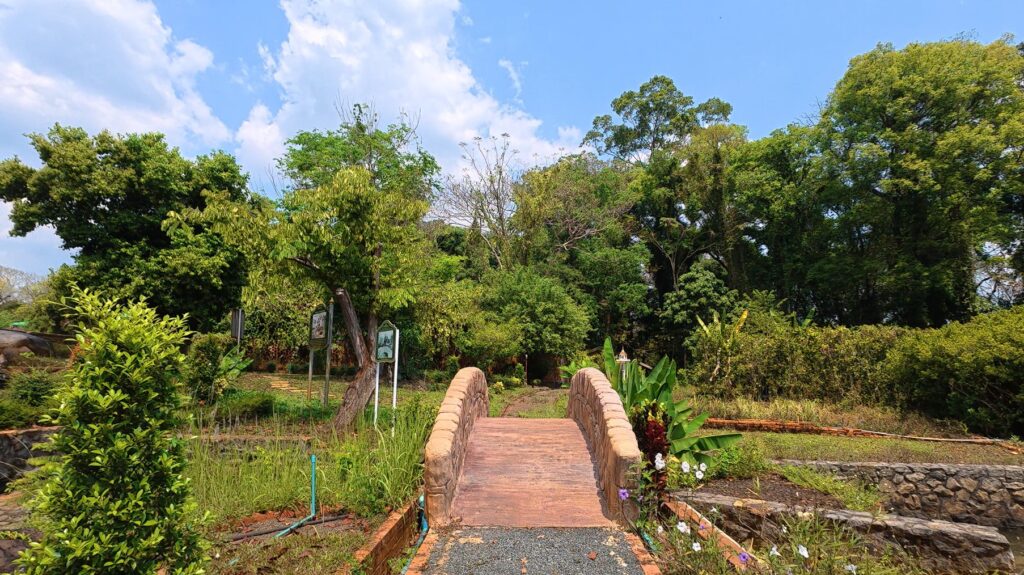 Stone bridge leading through the gardens of Suan Ban Kaew Palace