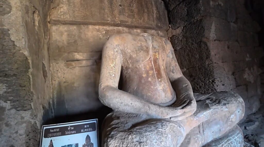 Seated Buddha inside the ancient chamber of Phra Prang Sam Yot in Lopburi