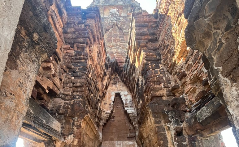 Interior brickwork and surviving decorative details inside an ancient prang in Lopburi