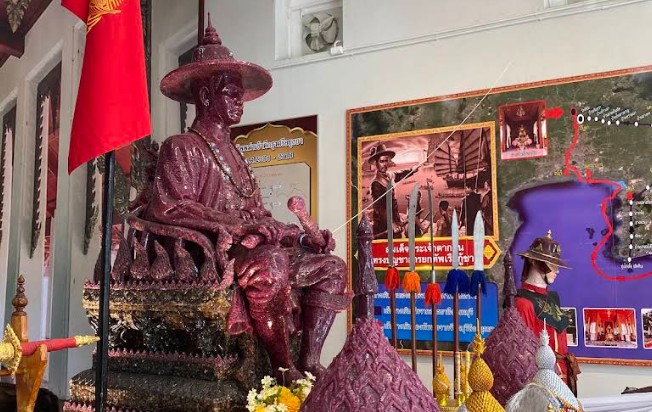King Taksin statue with historical maps and military displays in Chanthaburi, Thailand