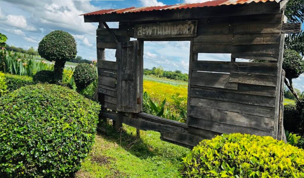 Old wooden entrance to Kae Dam Bridge in Maha Sarakham, Thailand
