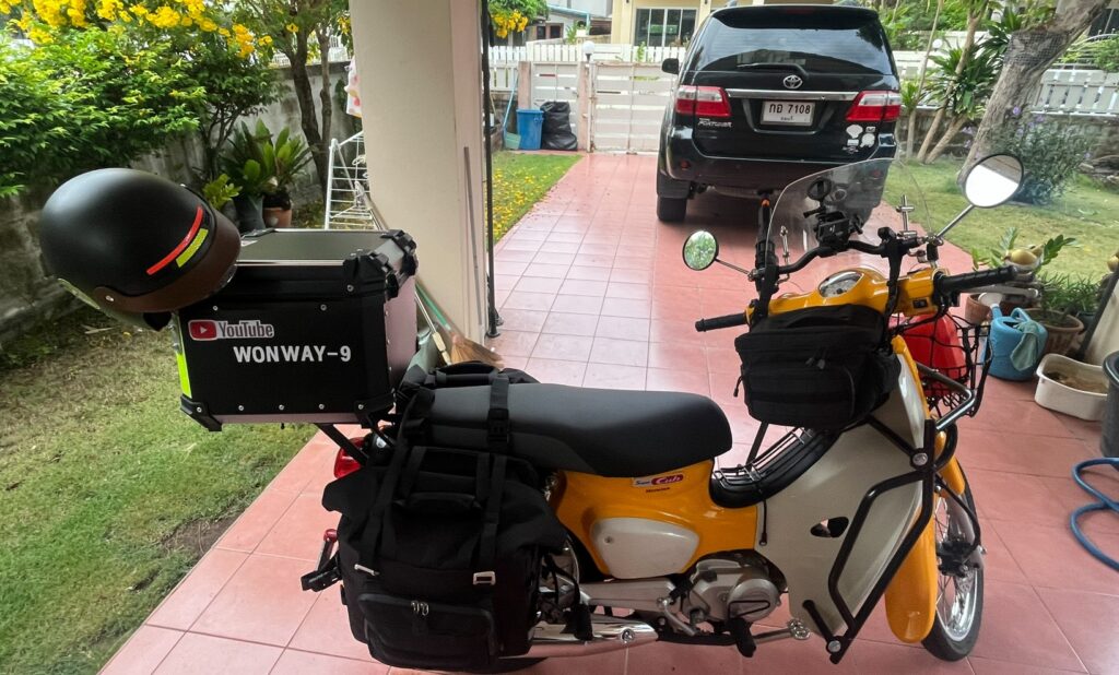 Yellow Honda Cub prepared for an early morning ride to Ban Pakkad Border