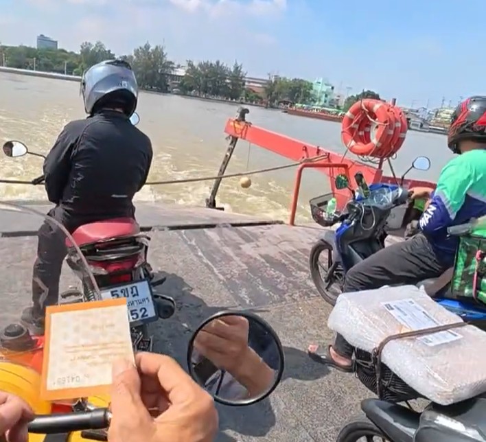 Motorcycles crossing the river on a local ferry near Bangkok