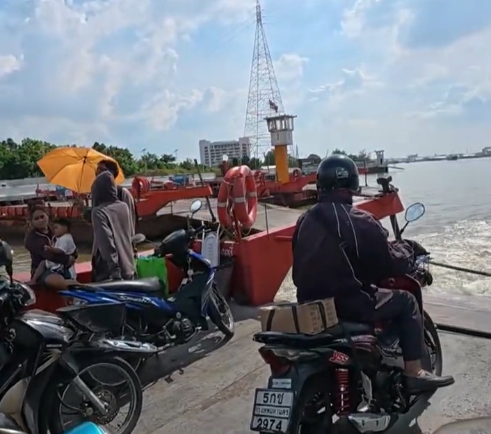 Honda Cub rider completing the Bangkok crossing by local ferry