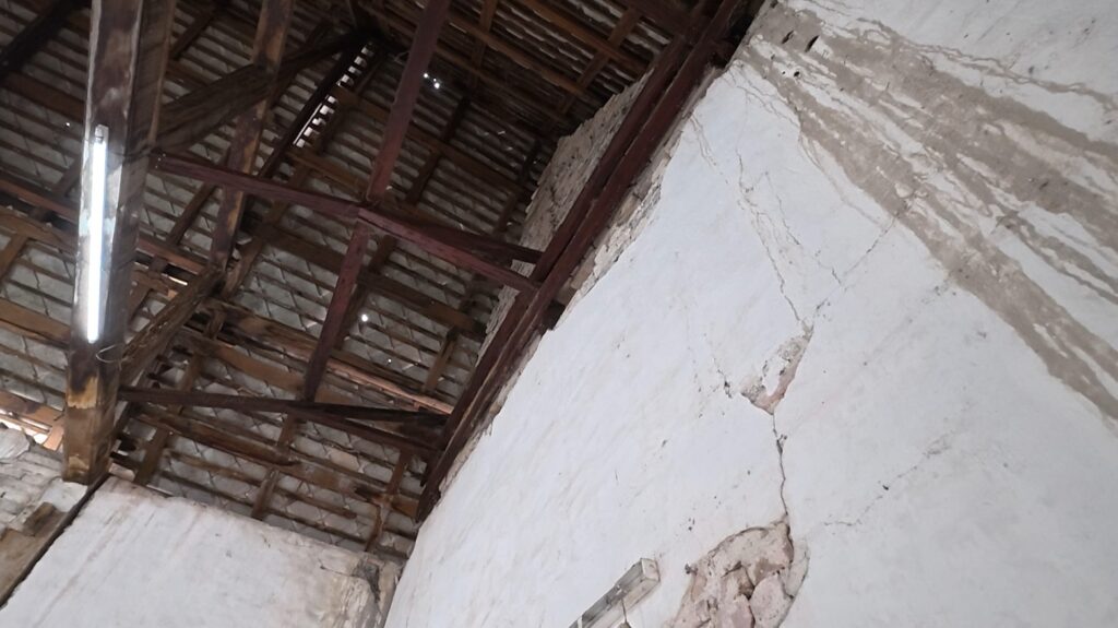 Aged wooden roof beams inside the old ubosot of Wat Khao Bot