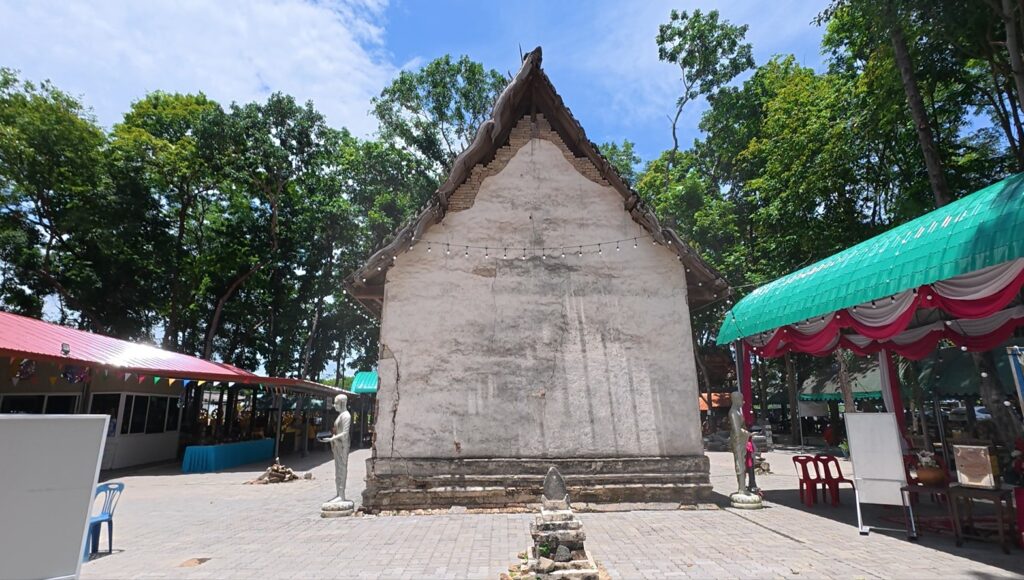 Buddha image and worshippers inside the old ubosot of Wat Khao Bot
