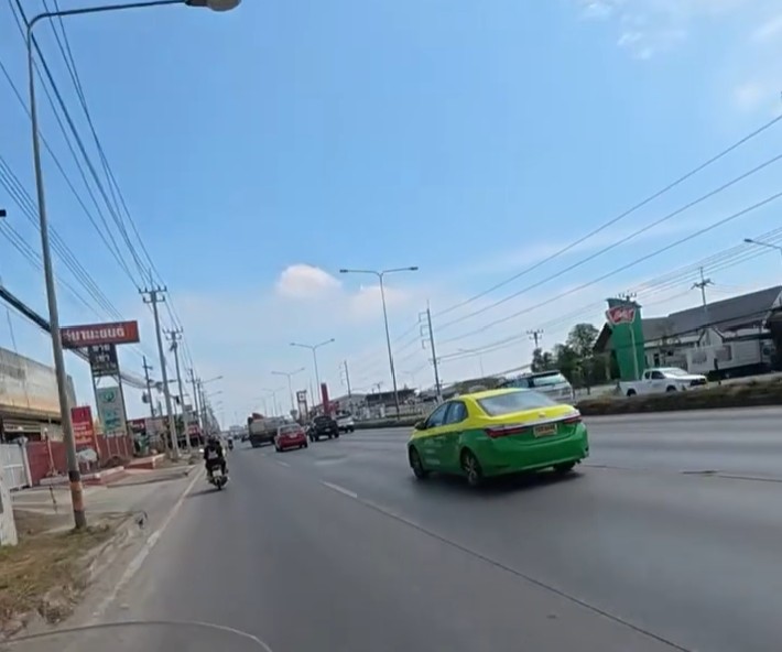 Approaching Bangkok from Kanchanaburi on a Honda Cub
