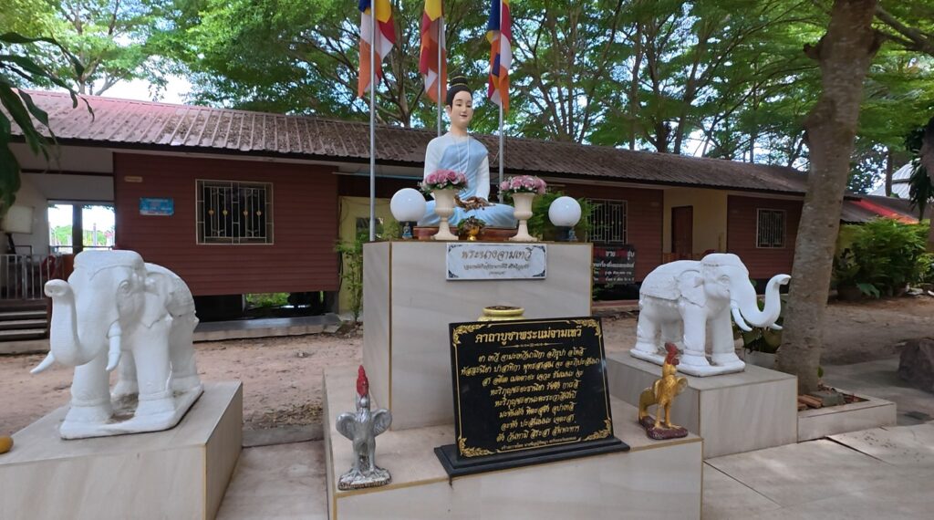 Statue and memorial associated with Queen Chamadevi at a Thai sanctuary