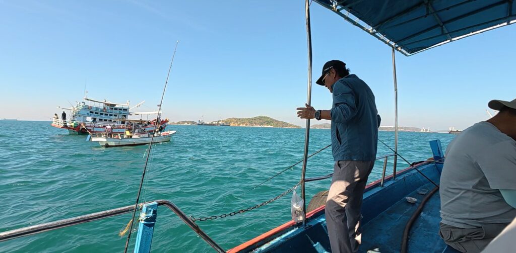 Friends ending a relaxed sea fishing day with a modest catch