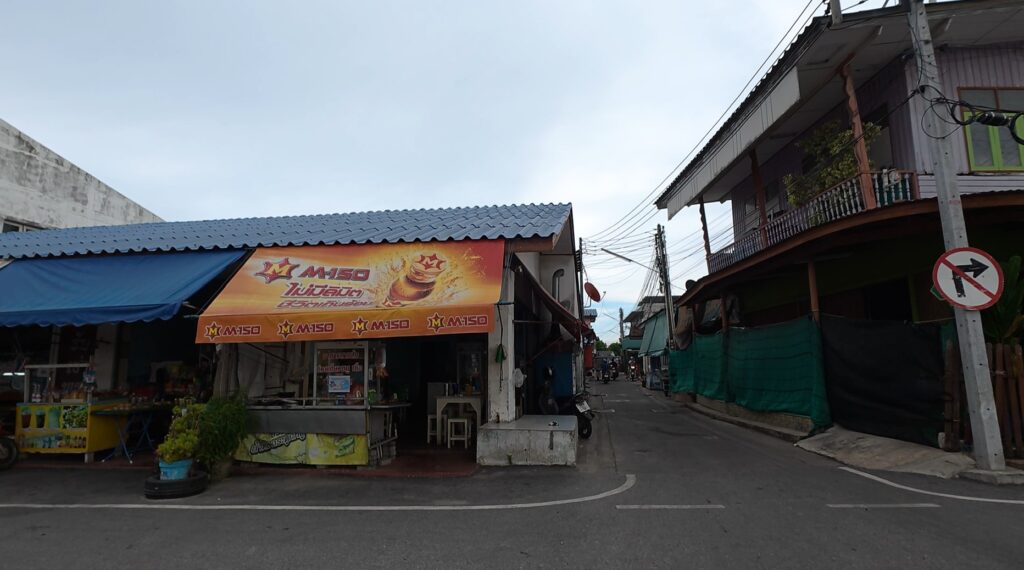 Road leading into the coastal community near Rayong harbour