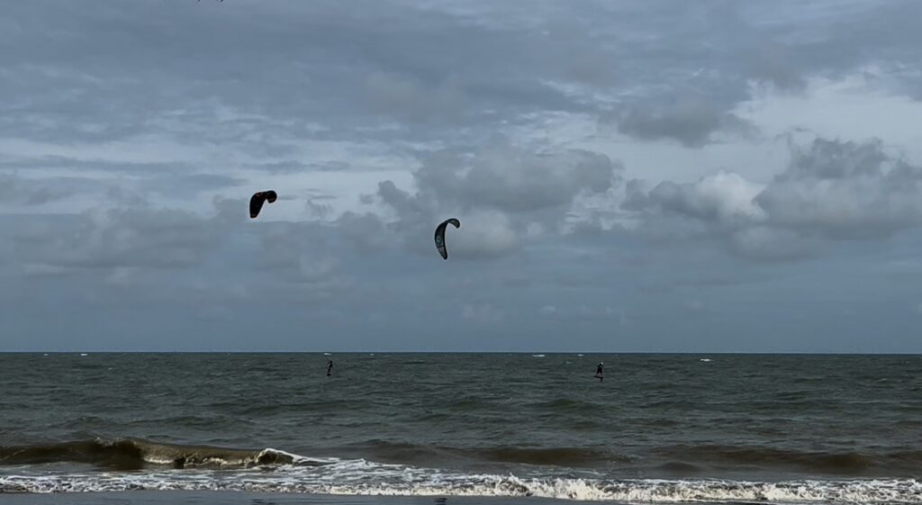 Kite surfers on the Gulf of Thailand near HTMS Prasae in Rayong