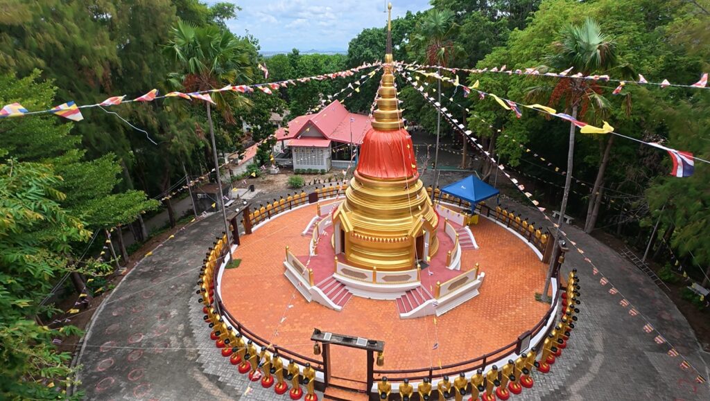 Golden stupa surrounded by trees at the hillside meditation center in Rayong
