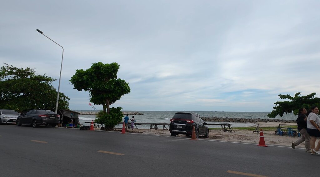 Motorcycles and houses in an old Rayong fishing village