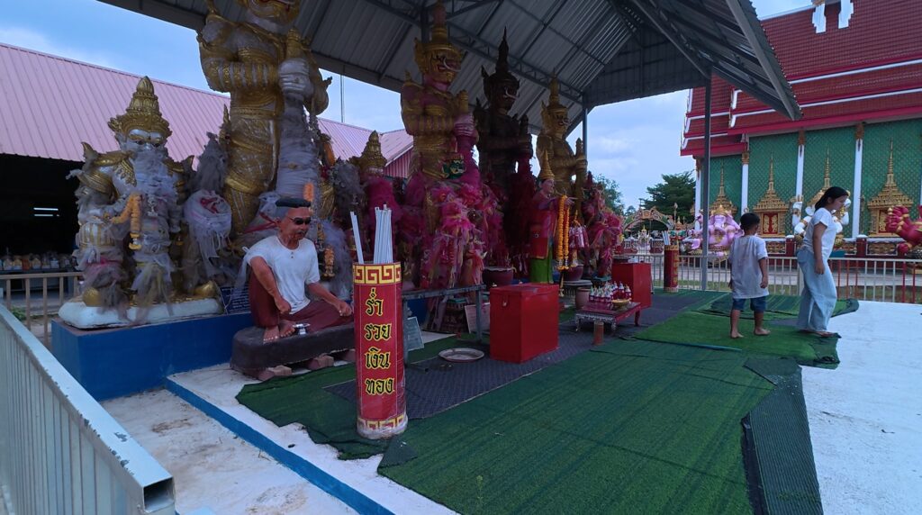 Local worshippers making offerings inside Wat Ang Kaeo temple