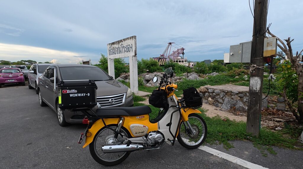 Honda Cub beside the coast at the end of a Rayong heritage ride