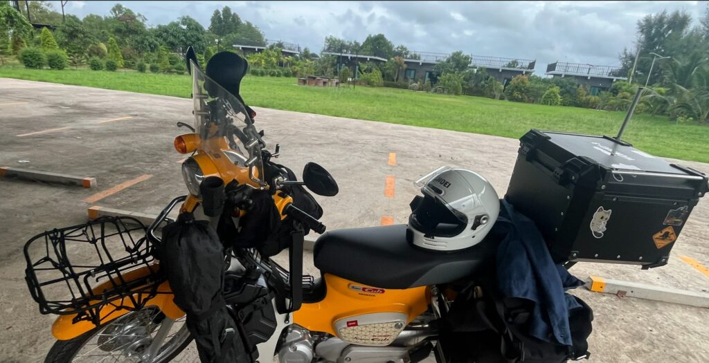 Honda Super Cub parked outside a small local resort near Wat Takhian Ngam in Rayong