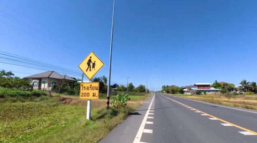 A quiet rural village road on the journey from Buriram to Roi Et