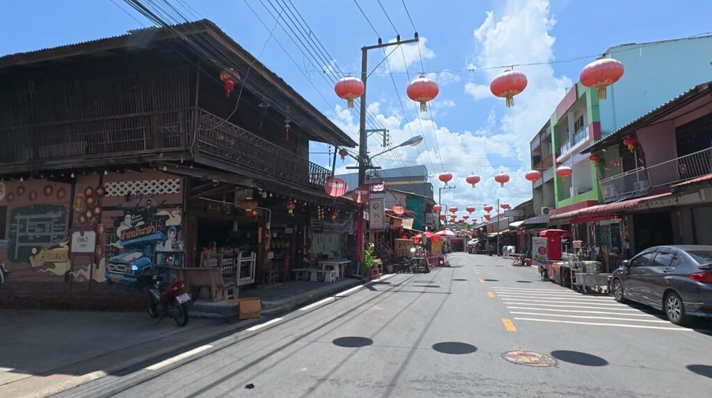 Red lanterns above the historic wooden shophouses of Chak Ngaew Chinese Market