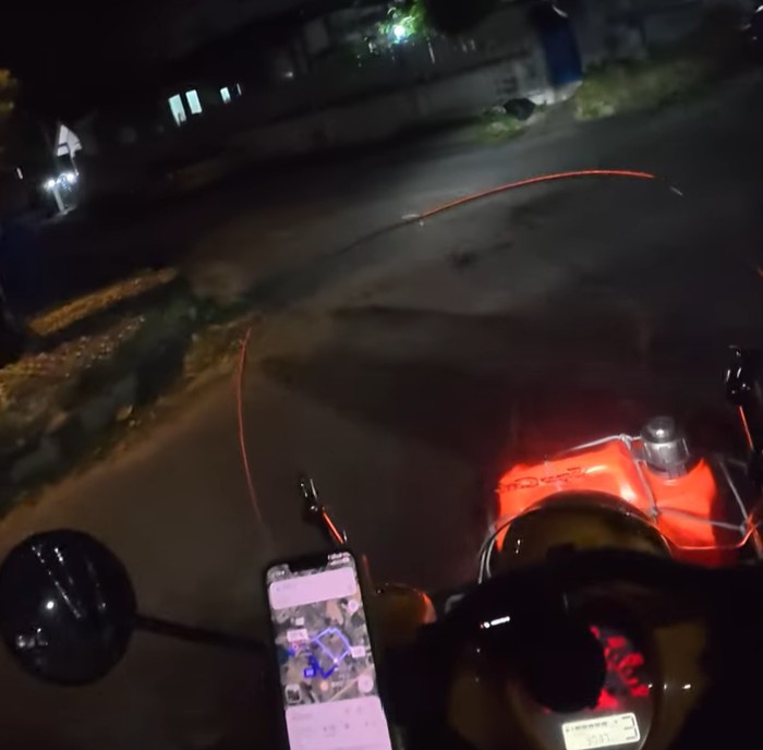 Final nighttime highway ride after twelve days traveling by Honda Cub