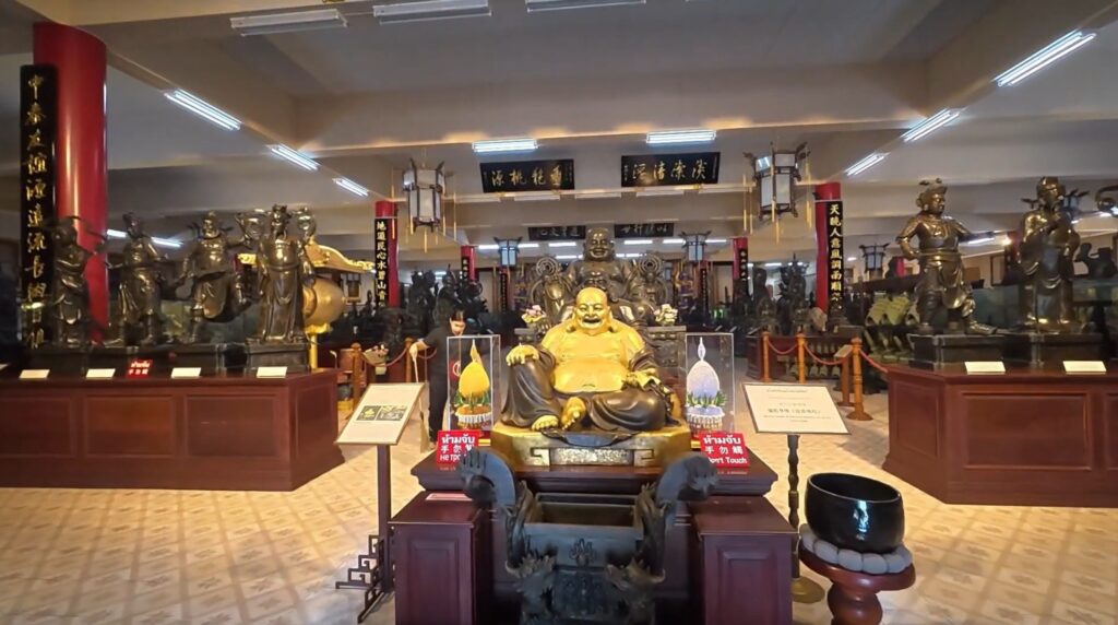 Chinese bronze statues displayed inside Viharn Sien near Pattaya