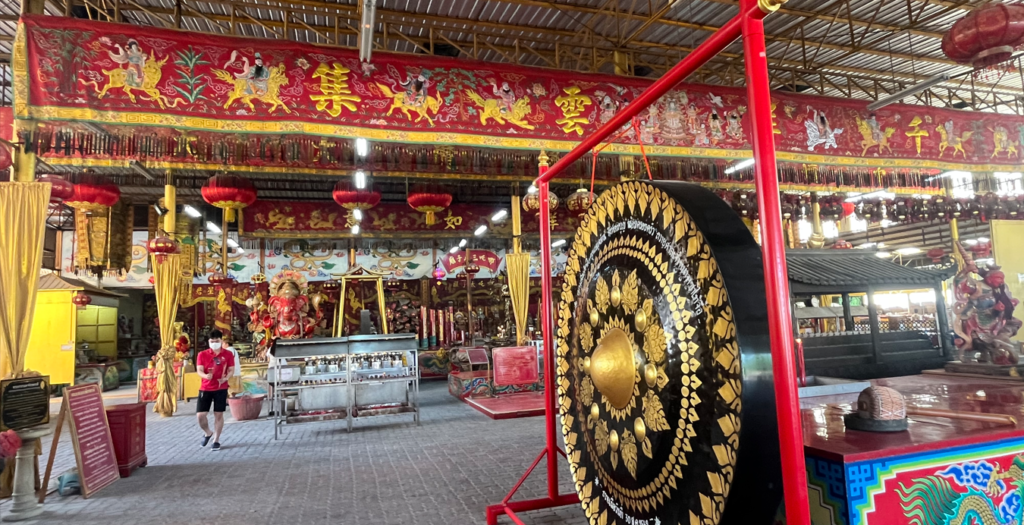 Large ceremonial gong inside Na Jasa Tai Chue Shrine in Chonburi