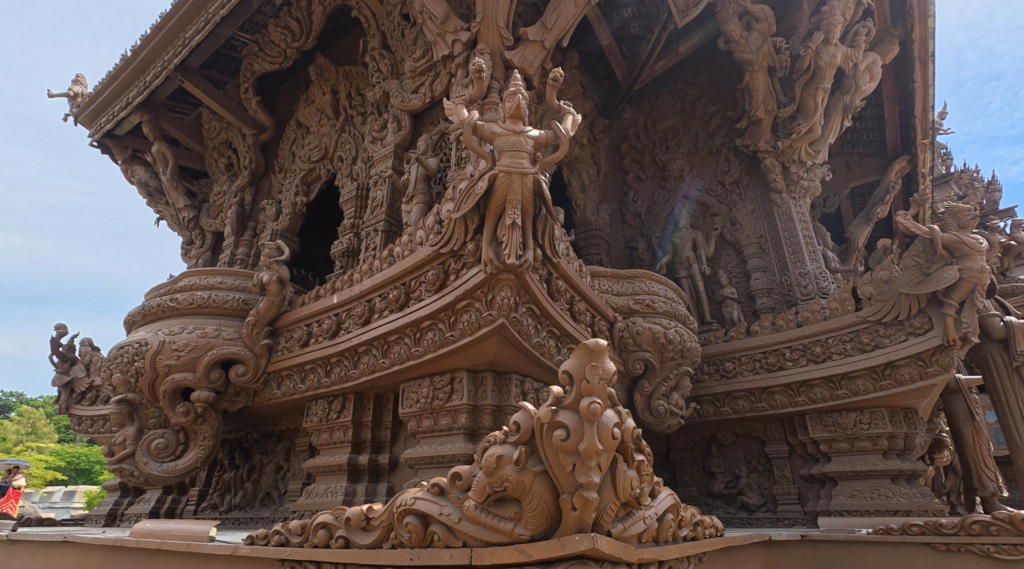Detailed wooden architecture and sculpted base of the Sanctuary of Truth in Pattaya
