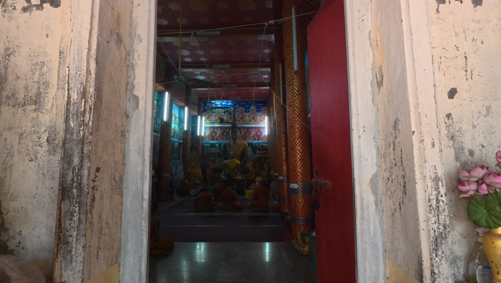 Entrance to the old ubosot during monks’ chanting at Wat Mai Ket Ngam