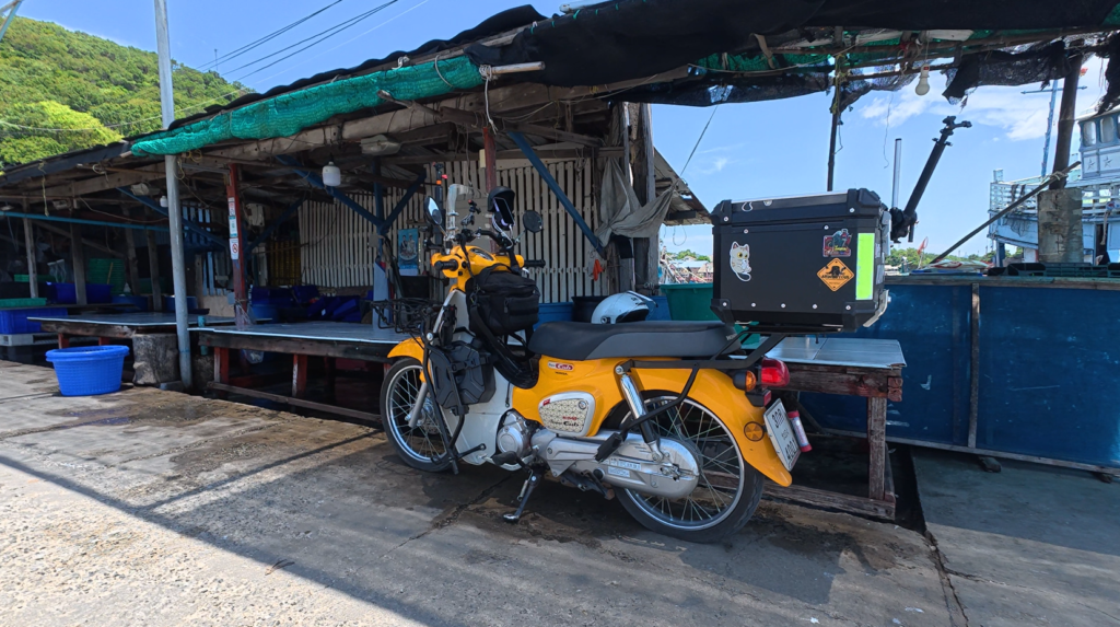 Honda Super Cub beside a fishing village near Laem Chabang