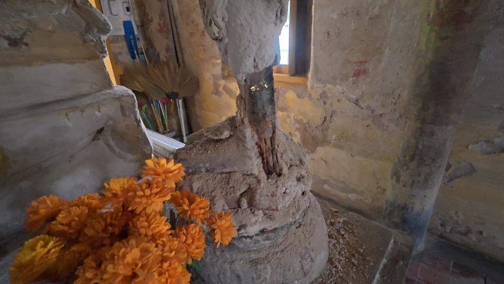 Severely damaged standing Buddhist figure inside Wat Tan Lom’s old ubosot
