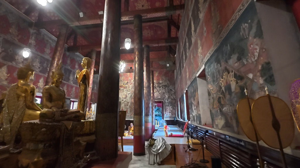 Painted columns and historic murals inside Wat Yai Intharam’s old ubosot