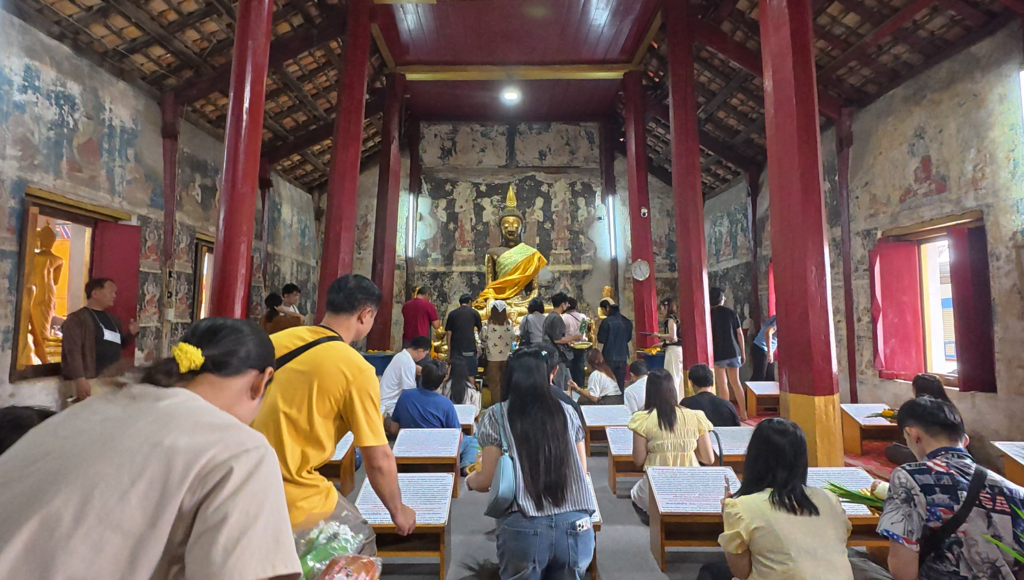 Worshippers inside the old ubosot of Wat Tao Pun Chonburi