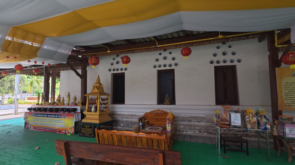 Historical information board beside the old ubosot at Wat Taphong Nai in Rayong

