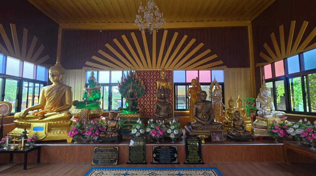 Interior view of the temple space containing manuscript and religious displays at Wat Taphong Nai
