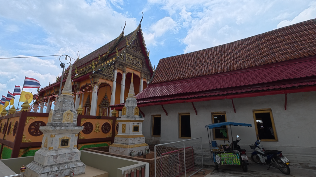 Historic and newer temple buildings standing together at Wat Tao Pun, Chonburi