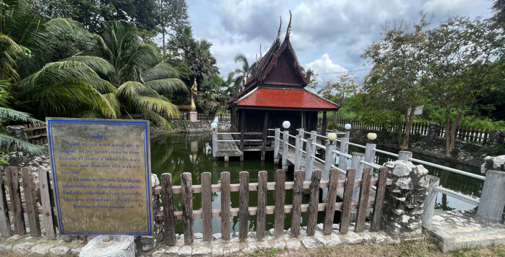Historic ho trai scripture library standing over a pond at Wat Ban Laeng in Rayong, Thailand.